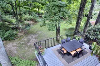 A Curvaceous Connecticut Home Asks $2.6M - Photo 7 of 8 - The kitchen leads to a deck, perfect for entertaining outdoors.