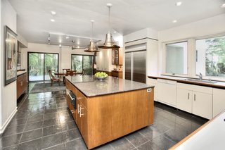 A Curvaceous Connecticut Home Asks $2.6M - Photo 6 of 8 - Bruce Lynn updated the kitchen and installed a new furnace and air conditioning. For furnishings, Lynn initially sought art deco and Biedermeier pieces at furniture auctions. Over the years, works by celebrated designers have become more available, such as Noguchi glass coffee tables and Frank Lloyd Wright chairs. Nearly all the hardware in the house is original; the doorknobs came from the same manufacturer that supplied Philip Johnson's Glass House.