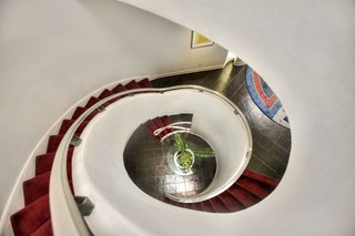 A Curvaceous Connecticut Home Asks $2.6M - Photo 4 of 8 - A spiraling staircase connects the home's three levels and leads into the foyer.