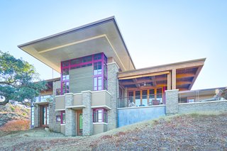 The deep red aluminum window exteriors are a nod to Frank Lloyd Wright's Fallingwater in Pennsylvania. Wright would visit Brian's mother's restaurant supply store in Madison, Wisconsin, where he picked up necessities to cook for his students.