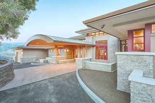 A redwood barrel vault entryway invites visitors to the house. An impressive feature that transitions from outdoor to indoor space, it posed a technical challenge. "Without much trim above or to the sides, the window fit really tightly into this arched entry," says Yaconelli. Kolbe Windows & Doors created the custom entryway to offer a personalized experience of coming home for the Haas family and guests.