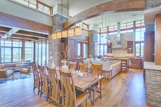 A few steps up from the living room, the open kitchen features a granite island, walnut cabinets, and stainless steel appliances. The surrounding clerestory windows usher in the light.