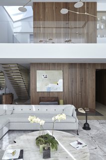 Both functional and aesthetically svelte, this panel and integrated door system hides an elevator and integrated hall storage.