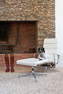 In the living area, a dry packet stone fireplace frames a fire grate that was forged by an expert blacksmith. 