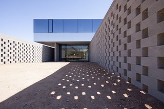Concrete block walls allow light and air to pass into the garden while maintaining a screen of privacy. 