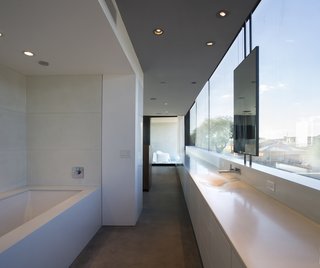 The master bathroom and dressing room join the master bedroom as one open suite.