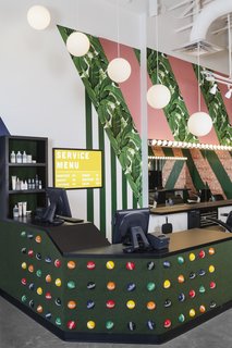 Artificial turf and croquet balls add texture and personality to the reception desk.