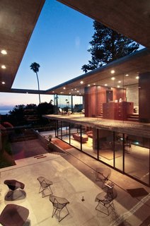 Though the house is made of interior and exterior volumes, the vertical walls and roof planes maintain the four corners of its rectangular form.
