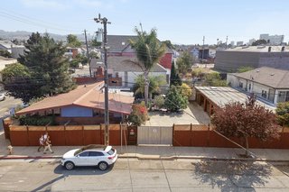 Dean explains that the compound is sandwiched between a private home and an industrial building, making it "literally the transition point from residential to commercial." 