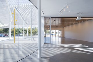 The lobby opens to the Community Education Room, creating a single stage for gatherings and programs. 