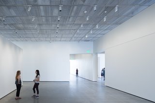 The exhibition spaces have polished concrete floors and custom aluminum mesh ceilings that are fitted with occupant-controlled LED lights. The museum is on course to be LEED-certified.