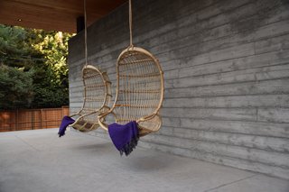 At AutoCamp, Sleep in a Slice of Americana for $225 a Night - Photo 4 of 10 - Hanging Rattan Chairs by Serena & Lily invite guests to curl up with a cup of tea and enjoy views of the meadow.
