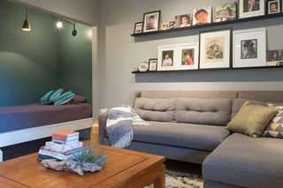 Wendi took advantage of the space under the stairs by installing a daybed; bedding is stored in a drawer hidden behind a baseboard. 