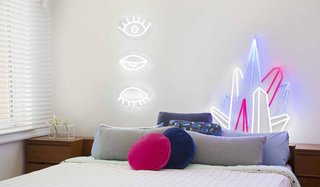 Eye! Eye! Eye! ($449) and Crystal Prism ($449) decorate a bedroom. Electric Confetti's designs come with a remote control that allows you to dim the neon to less than 5% brightness, ideal for a nightlight, or set it to an adjustable flashing speed.