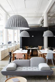 Muuto Under the Bell pendant lights are made from recycled plastic felt, which helps absorb noise and improve acoustics—a key feature in the open office.