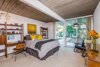 The master bedroom enjoys a spacious walk-in closet and opens to the backyard.