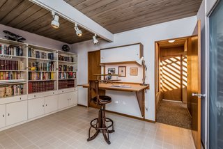 Built-in cabinets make this converted bedroom an ideal library.