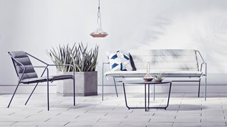 Copper lanterns ($34.99 for the large) add metallic accents to an outdoor setting. The Outdoor Sofa in gray, $399.99, gets an extra layer of comfort with the Sofa Cushion in gray, $109.99.