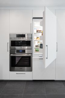 While the cooking appliances remain in the open, the Bosch refrigerator, freezer, and dishwasher are integrated into the cabinetry. "They're hidden to create a furniture aesthetic," says Brunn, which was a priority to allow the kitchen to flow into the rest of the home.