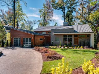 Western red cedar, natural stone, stucco, and brick form a warm exterior. The standing metal metal roof, under warranty through 2055, withstands winds up to 110 miles per hour. Automatic LED lighting illuminates the entry at night. 