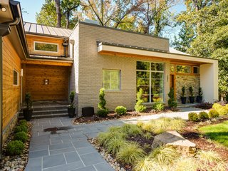 The landscaping features encore azaleas, arborvitae, and Japanese cypress. An oak forest in the backyard provides a sense of privacy and seclusion. 