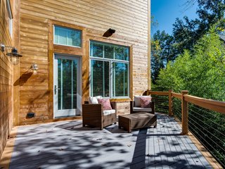 Approximately 516 square feet, the back deck is comprised of two-toned cedar and gray composite wood. Four all-weather speakers provide entertainment, and the reinforced left side allows for hot tub installation. 