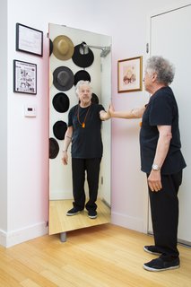 Ideal for entries and narrow hallways, the Giralot storage unit swivels open and closed on a wall-mounted column. Here, Alan's shoe rack doubles as a full-length mirror.