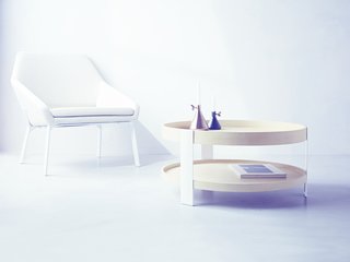 The Wait Is Over: Modern by Dwell Magazine Arrives at Target - Photo 1 of 9 - Boasting a comfortable cradle shape, the Lounge Chair ($249.99) is the perfect spot to relax. Copper and black Wingnut Candleholders ($19.99) perch on a Coffee Table ($149.99) in a natural/white finish.