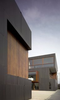 Live Outside the Box in This Artist’s Haven For $3.5M - Photo 1 of 8 - "When it comes to materials, we tended to borrow from fashion thinking—texture, color, textile, stitching, seaming, etc. are what inspires us," says Liang. Sunken patches in the zinc cladding give the exterior texture, and sustainably grown and harvested Brazilian ipe wood provides a contrasting trim.