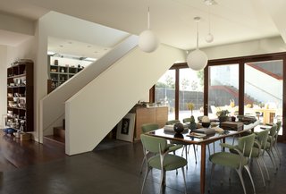 Live Outside the Box in This Artist’s Haven For $3.5M - Photo 4 of 8 - The open plan of the main house combines living, dining, and kitchen areas. A courtyard sandwiched between the main house and the studio structure offers an outdoor platform for entertaining.