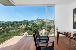 The guest bedroom, shown here as an office, offers an uninterrupted view of the surrounding canyon. "Walking into the space, it's just breathtaking," says JB Fung, agent and director of Aaroe Architectural.