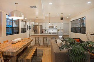 Preston and his friends at Icon Homes opted for an open floor plan that integrates the living, dining, and kitchen areas. "We went for a monochromatic look," says Preston. White oak plank flooring runs throughout the entire home.