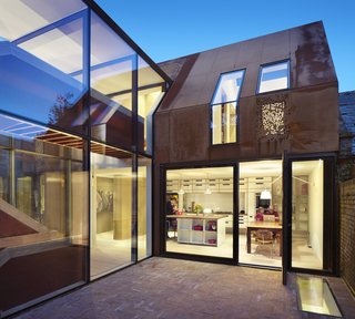 A flight above the living room, a kitchen and dining area opens onto a walled rear courtyard. The wing also includes a pantry, a walk-in closet, laundry room, and bathroom.
