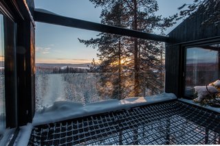 An extension of Treehotel’s mission of bringing modern design to a serene natural environment, the 7th Room is a cabin lofted among the treetops that blurs the distinction between indoors and outdoors. Designed by the renowned firm Snøhetta, the structure hovers 10 meters above the ground with a black-and-white print of the canopy covering the bottom façade, creating a trompe l'oeil effect. The two bedrooms, bathroom, lounge area, and netted terrace are arranged across two slightly different levels, accommodating up to five guests. Barring a fear of heights, you can choose to lay your sleeping bag on the double-layered net that connects the two bedrooms and enjoy a night under the stars.