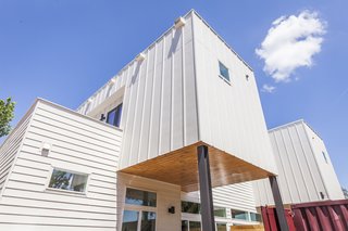 Rios asked architect Reynolds to derive a design from the shipping containers. The duplex takes the shape of stacked volumes clad with vertical and horizontal Hardie boards. The covered patio features clear-coated cedar wood.