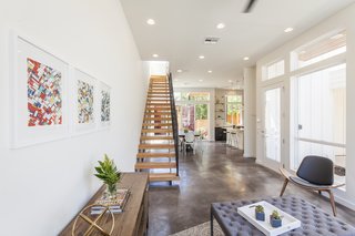 A stained concrete floor gleams throughout the first floor. "The staircase is a real showstopper," says Rios, "connecting to the industrial steel of the containers, but warmed by wooden beams."