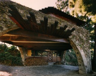 Find Seclusion in the City With This $2.5M Lloyd Wright Residence - Photo 7 of 7 - An office space is tucked under the arch spanning the driveway.