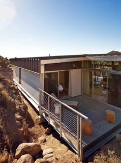 Offered at $674K, This Hybrid Prefab Is in Tune With the Californian Desert - Photo 6 of 7 - The back patio forms a corner between the master bedroom and main living area, creating a contemplative space for reading, relaxing, or simply enjoying the view.