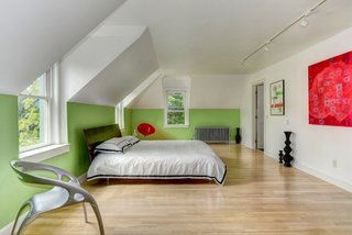 The master bedroom connects to a walk-in closet and a smaller room that is plumbed to become an ensuite bathroom, though it's currently an office. "All the windows are facing south, so in the winter, when light is precious in the Northeast, it just pours in and warms the whole space up," says Reed.