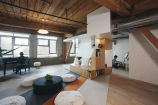 CHA:COL took acoustic concerns into consideration when designing the final environment. In addition to the one facade of windows, a Zaneen pendant illuminates the loft.