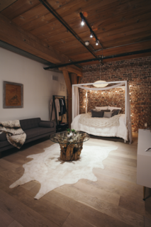 The sleeping area is tucked into the back of the loft. Says Misra of the clients, "As they moved in and felt the energy of the place, they admitted they could see themselves staying here more and more and commuting less and less." 