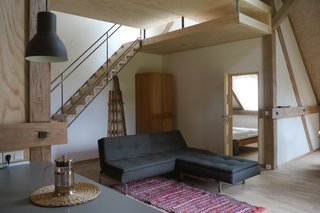 Built in the haylofts of former stables, three loft-style apartments with ample windows and clay plaster walls each have their own personality. Stable North, pictured above, sleeps two in the bedroom and two others in a mezzanine space.