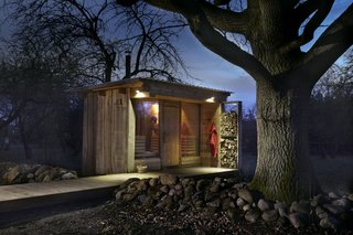 Stacked firewood powers the wood oven that heats the sauna to 70 degrees—a warm, enveloping temperature that is gentler on the circulatory system.