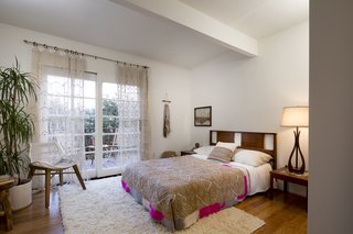 The third bedroom on the main floor opens out onto a private terrace and has an additional space for storage or laundry. The house boasts a bonus room on the lowest floor that can be reached from an exterior stairwell.