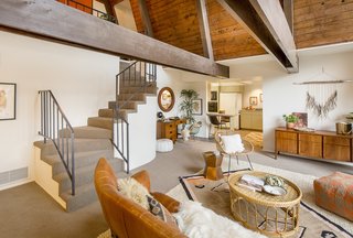 Descending the staircase, you enter the open living area. Says the seller's son of the 1,701-square-foot space, "It's humble in size, but grand in its impact."