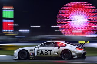 Night falls, the track is slick with rain, and the atmosphere of the infield grows more delirious as fans stay up to watch the race unfold.