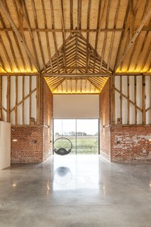 "Every window, every doorway, has some stunning view," gushes Smith. "You have a panoramic view of the country that changes with the weather. That’s why we could keep everything really plain; each opening brings interest to a plain room." 