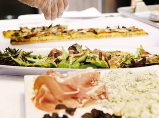 Flatbread topped with prosciutto, stilton cheese, figs, and arugula was part of the menu at Signature Kitchen Suite's impressive 4,000-square-foot exhibition booth.