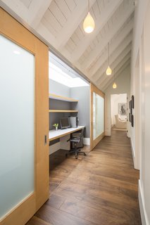 Skylights illuminate this tucked-away desk, which the homeowner can hide by sliding the doors closed.