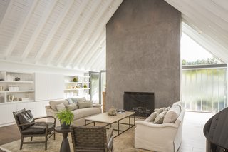 The living room feels more spacious than it already is thanks to ceilings that stretch 12 feet high. The built-in storage module houses a hideaway workspace and provides a buffer between the bedrooms and the common space. 